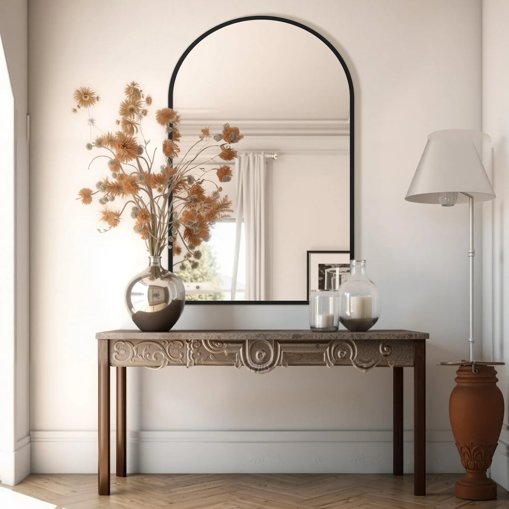 Decorative console table with mirror, vase, and lamp in a room setting.
