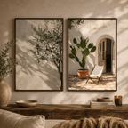 Two framed botanical wall art prints hang above a wooden console in a styled interior. The left print shows a tree branch with soft shadowing on a warm beige background.