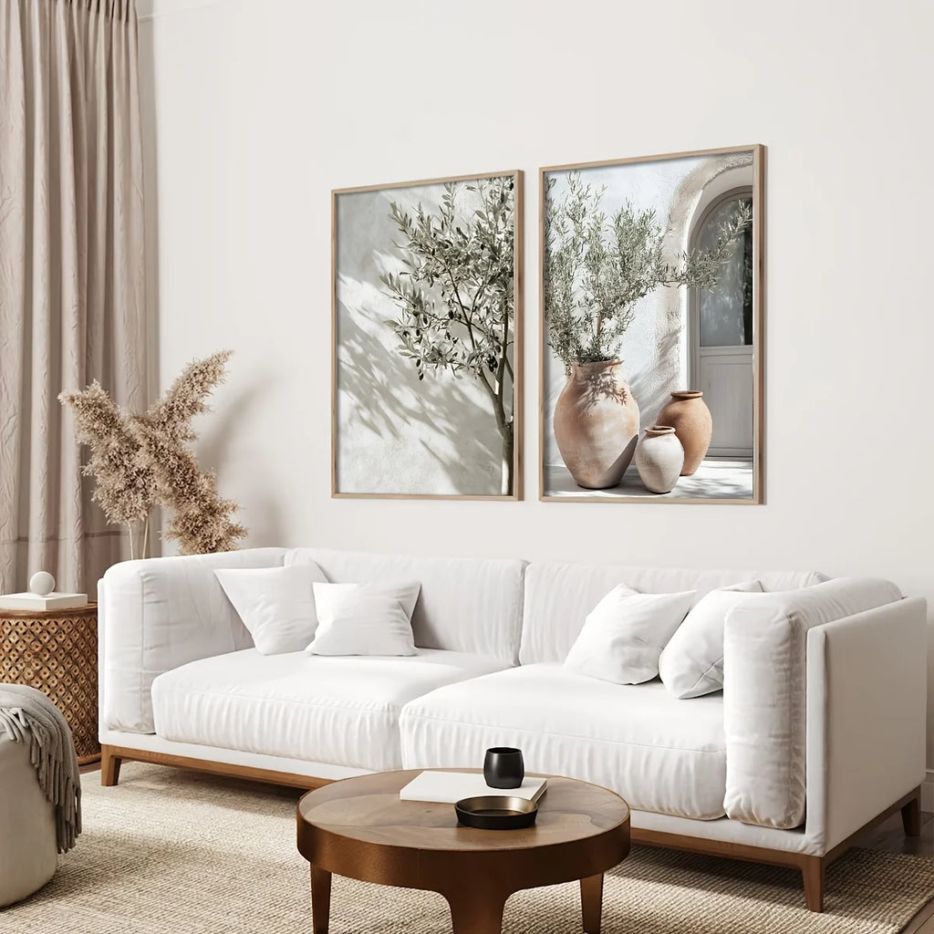 Modern living room with a white sofa, wooden coffee table, and two framed artworks on the wall.