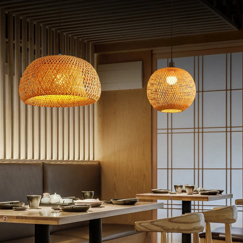 Restaurant interior with wicker pendant lights and wooden tables.